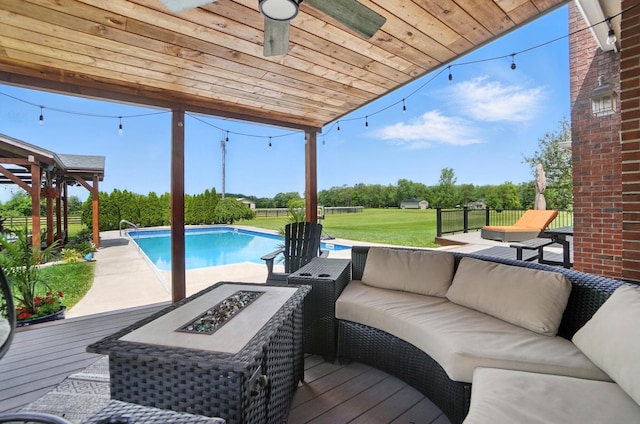 891 N Tecumseh Rd, Springfield, OH 45504 - swimming pool with a wooden deck, an outdoor living space with a fire pit, and a yard