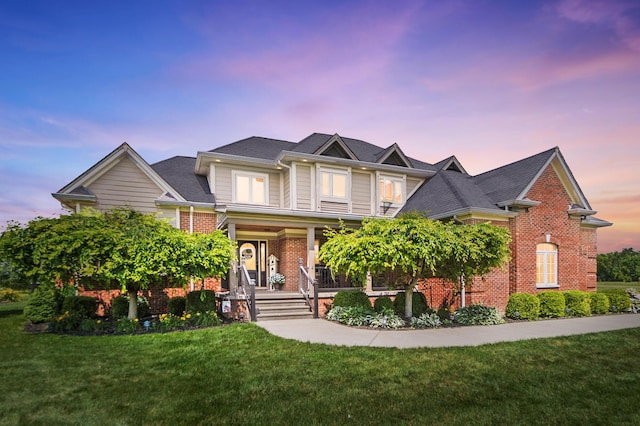891 N Tecumseh Rd, Springfield, OH 45504 - view of front of house with brick siding, a porch, and a front yard