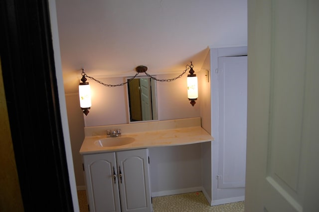 bathroom featuring baseboards and vanity