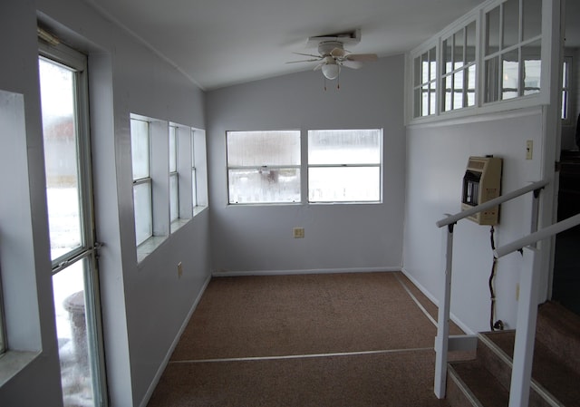 carpeted empty room with lofted ceiling, plenty of natural light, baseboards, and ceiling fan