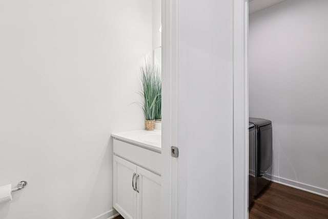 8202 Cherry Birch Dr, Tipp City, OH 45371 - bathroom with washer and dryer, vanity, and wood finished floors