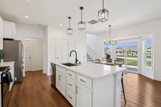 8202 Cherry Birch Dr, Tipp City, OH 45371 - kitchen featuring dark wood-style floors, recessed lighting, white cabinetry, pendant lighting, and light countertops