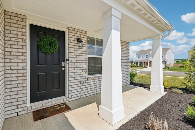 8202 Cherry Birch Dr, Tipp City, OH 45371 - doorway to property with a porch and brick siding