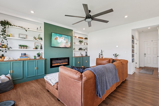8202 Cherry Birch Dr, Tipp City, OH 45371 - living room featuring wood finished floors, a glass covered fireplace, ceiling fan, recessed lighting, and built in features