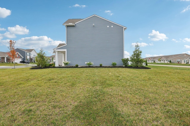 8202 Cherry Birch Dr, Tipp City, OH 45371 - view of side of property with a residential view and a lawn