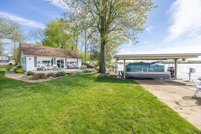 14072 Seminole Path, Lakeview, OH 43331 - view of green lawn featuring a carport, a boat dock, boat lift, and concrete driveway