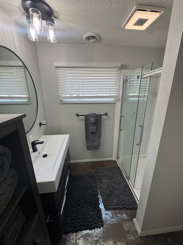14072 Seminole Path, Lakeview, OH 43331 - full bath with vanity, a shower stall, a textured ceiling, baseboards, and plenty of natural light