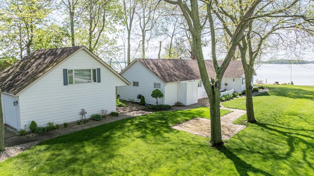 14072 Seminole Path, Lakeview, OH 43331 - view of side of home with a lawn, a water view, and roof with shingles