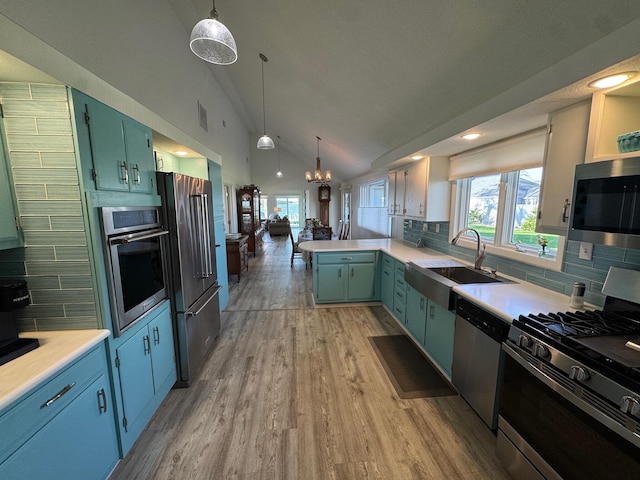 14072 Seminole Path, Lakeview, OH 43331 - kitchen featuring appliances with stainless steel finishes, a sink, vaulted ceiling, decorative backsplash, and recessed lighting
