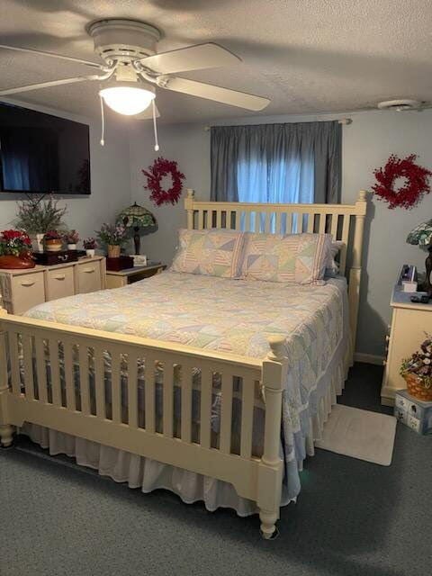 carpeted bedroom with a textured ceiling and ceiling fan