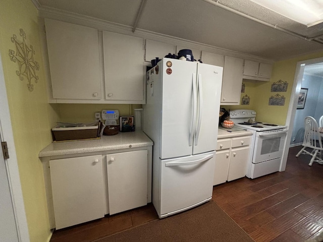 kitchen featuring light countertops, white cabinetry, dark wood-style floors, and white appliances