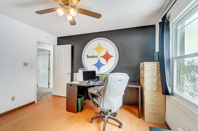 home office featuring light wood-style floors, baseboards, and a ceiling fan