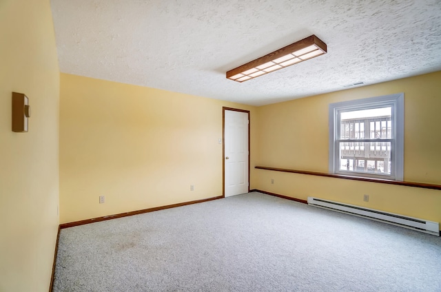 carpeted spare room with a baseboard radiator, visible vents, baseboards, and a textured ceiling