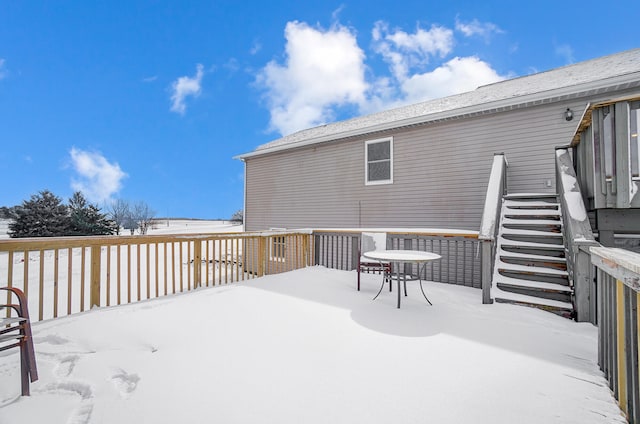 snow covered deck with stairs