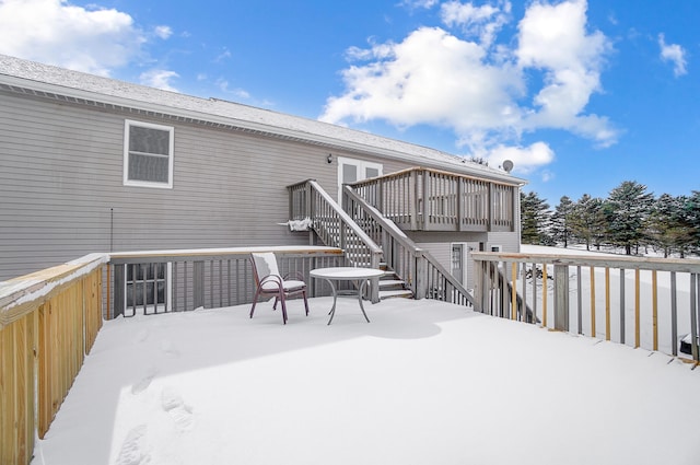 snow covered deck with stairs