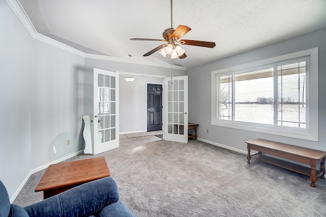 living area featuring baseboards, ceiling fan, ornamental molding, carpet flooring, and french doors