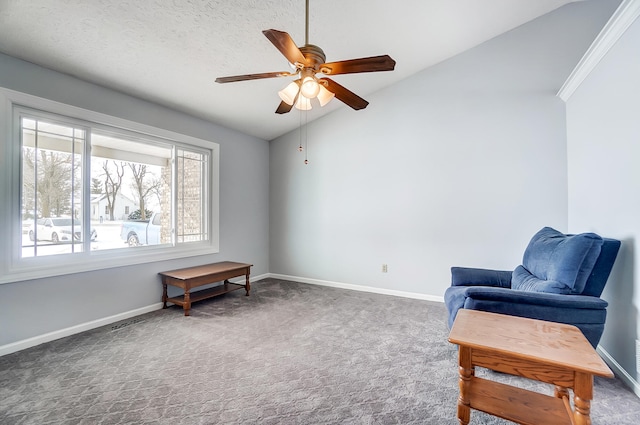 living area with a ceiling fan, vaulted ceiling, dark carpet, and baseboards