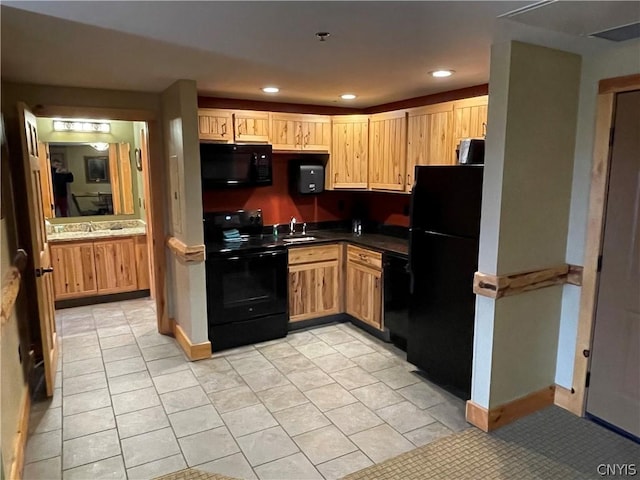 kitchen with light tile flooring, sink, light brown cabinets, and black appliances