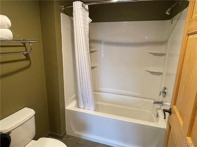 bathroom featuring tile floors, shower / bath combo, and toilet