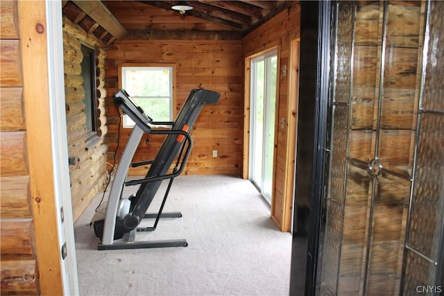 exercise area featuring carpet floors and wood walls