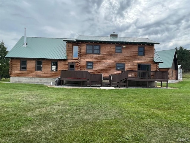 back of house with a lawn and a deck