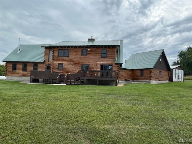 rear view of house featuring a deck, a yard, and a patio