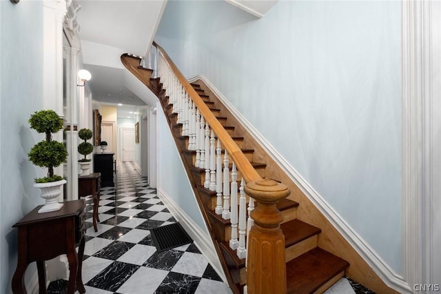 stairs with dark tile floors