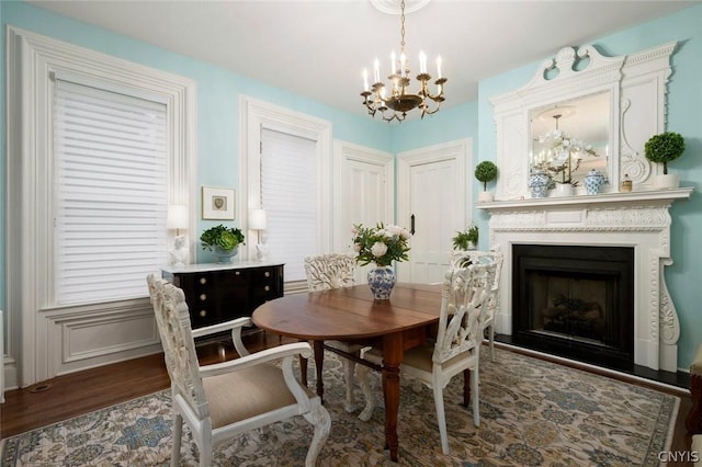 dining area featuring an inviting chandelier and dark hardwood / wood-style flooring