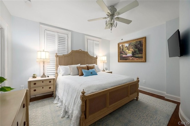 bedroom with ceiling fan and dark wood-type flooring