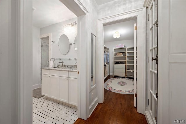 bathroom with french doors, vanity, and hardwood / wood-style flooring