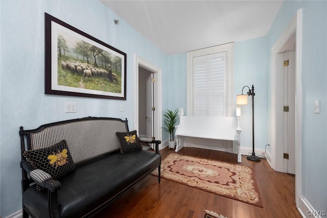 sitting room with dark hardwood / wood-style flooring