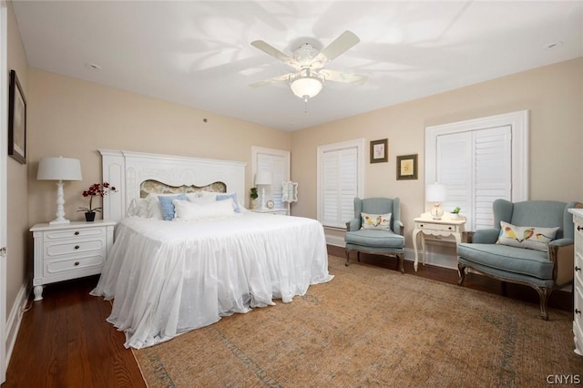 bedroom with ceiling fan and dark wood-type flooring