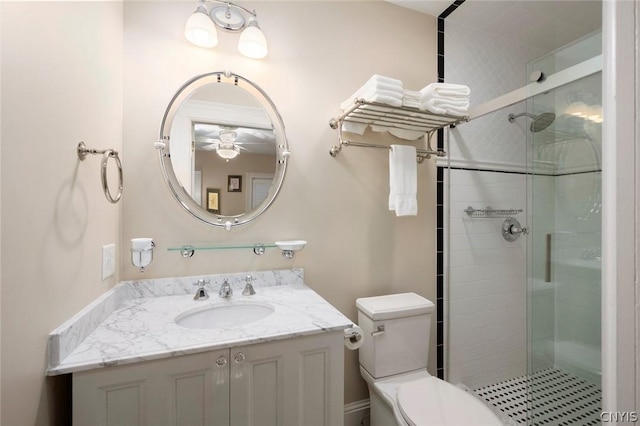 bathroom with toilet, ceiling fan, an enclosed shower, and vanity