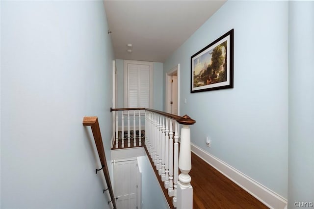 stairway with dark hardwood / wood-style flooring