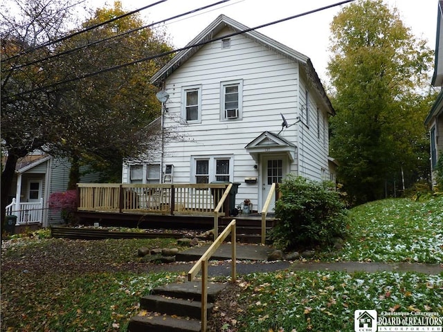 rear view of property with a wooden deck