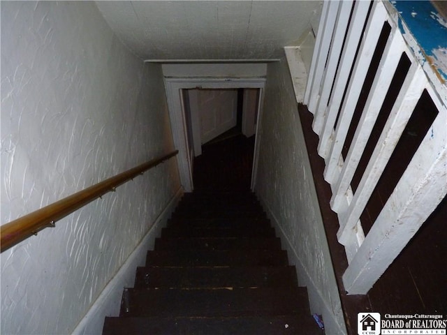 stairway featuring dark hardwood / wood-style flooring