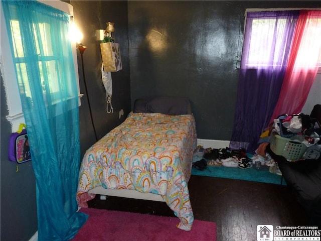 bedroom with dark hardwood / wood-style floors