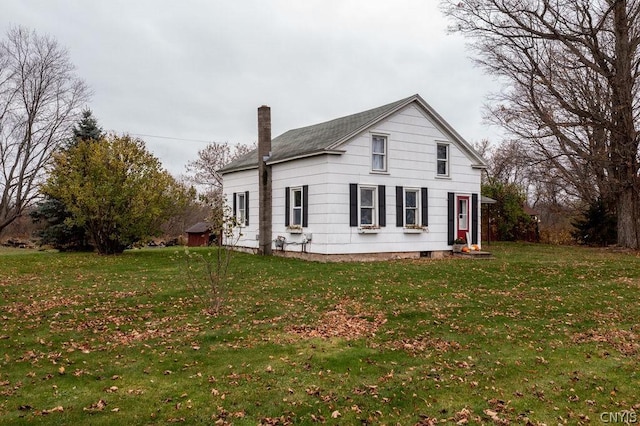 rear view of property with a yard