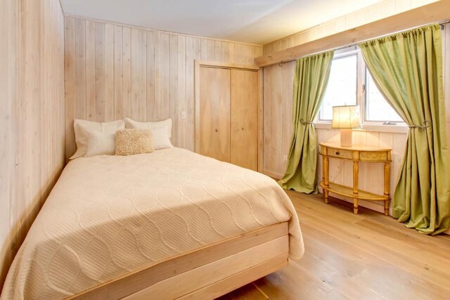 bedroom featuring a closet and light wood-type flooring