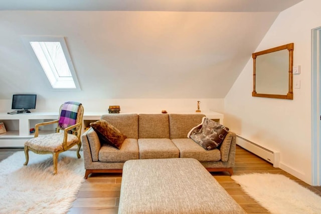 living room with light hardwood / wood-style flooring, baseboard heating, and vaulted ceiling with skylight