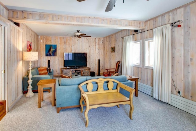 living room featuring wooden walls, ceiling fan, and light colored carpet