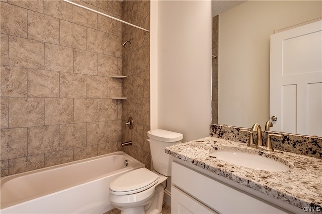 full bathroom with toilet, tiled shower / bath combo, and vanity