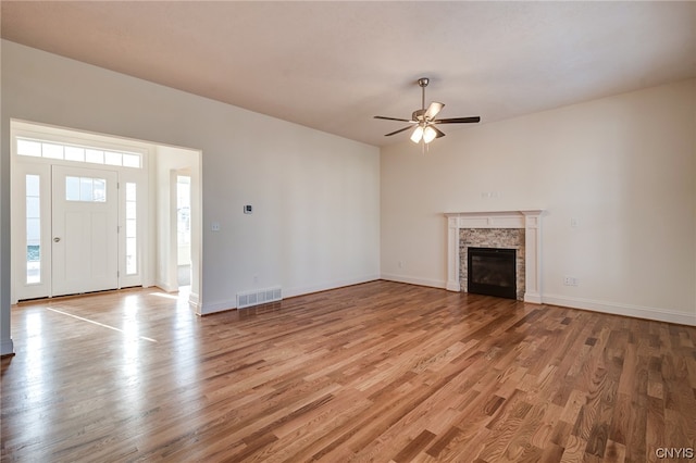 unfurnished living room featuring ceiling fan and light hardwood / wood-style flooring