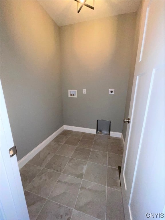 washroom featuring washer hookup, electric dryer hookup, and dark tile floors