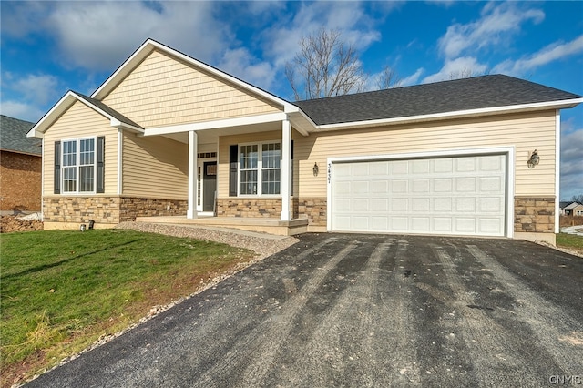 view of front of house with a front yard and a garage