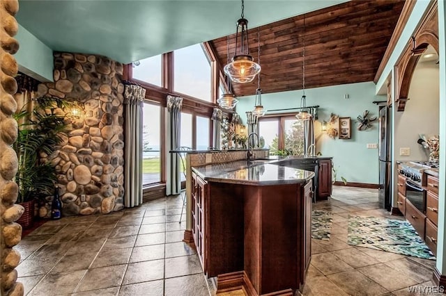 1567 Lake Rd, Porter, NY 14174 - kitchen featuring plenty of natural light, light tile flooring, wooden ceiling, and pendant lighting