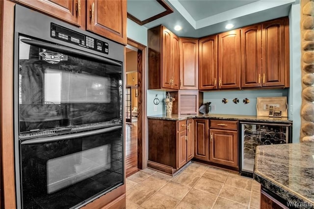 1567 Lake Rd, Porter, NY 14174 - kitchen featuring wine cooler, dark stone counters, black double oven, and light tile floors