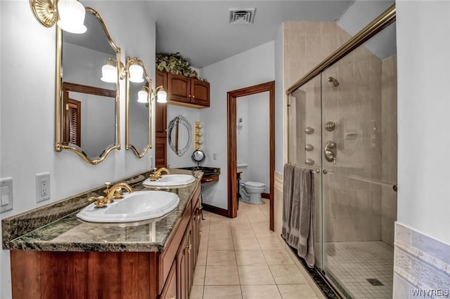 1567 Lake Rd, Porter, NY 14174 - bathroom featuring toilet, large vanity, dual sinks, tile floors, and an enclosed shower