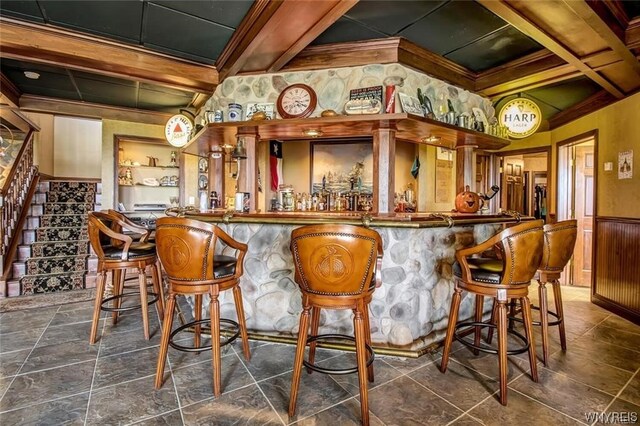 1567 Lake Rd, Porter, NY 14174 - bar featuring dark tile floors, beam ceiling, and ornamental molding