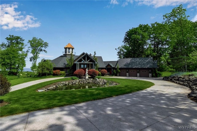 1567 Lake Rd, Porter, NY 14174 - view of front of house with curved driveway, a front yard, and a garage
